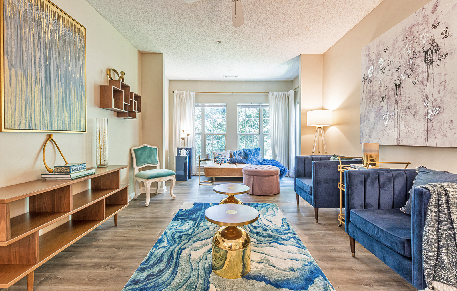 a living room with blue furniture and a large window